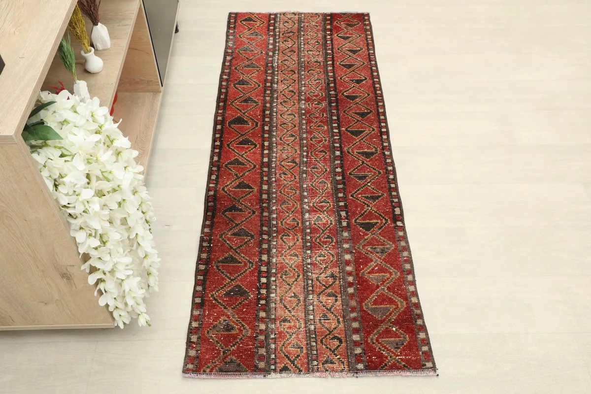 Overhead view of the red runner rug, highlighting its striped geometric patterns and colors.