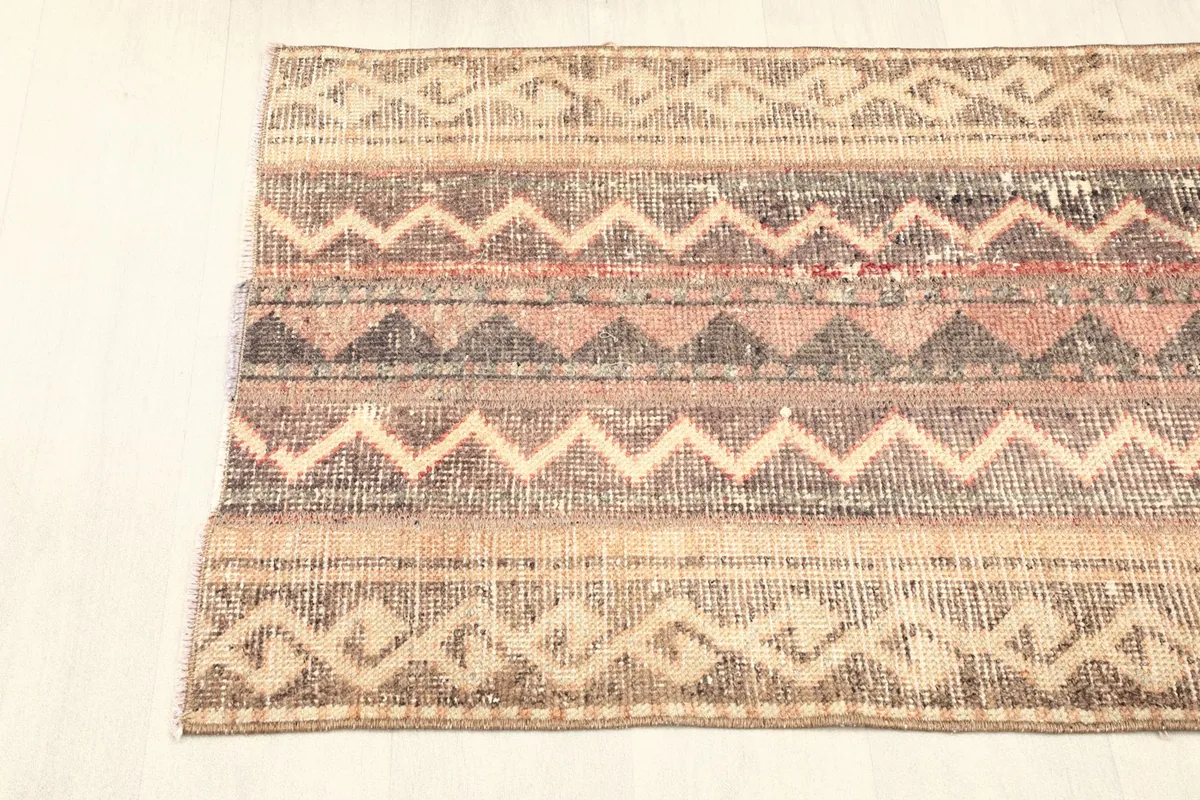 View along one edge of the rug, displaying the distinctive tribal border patterns.