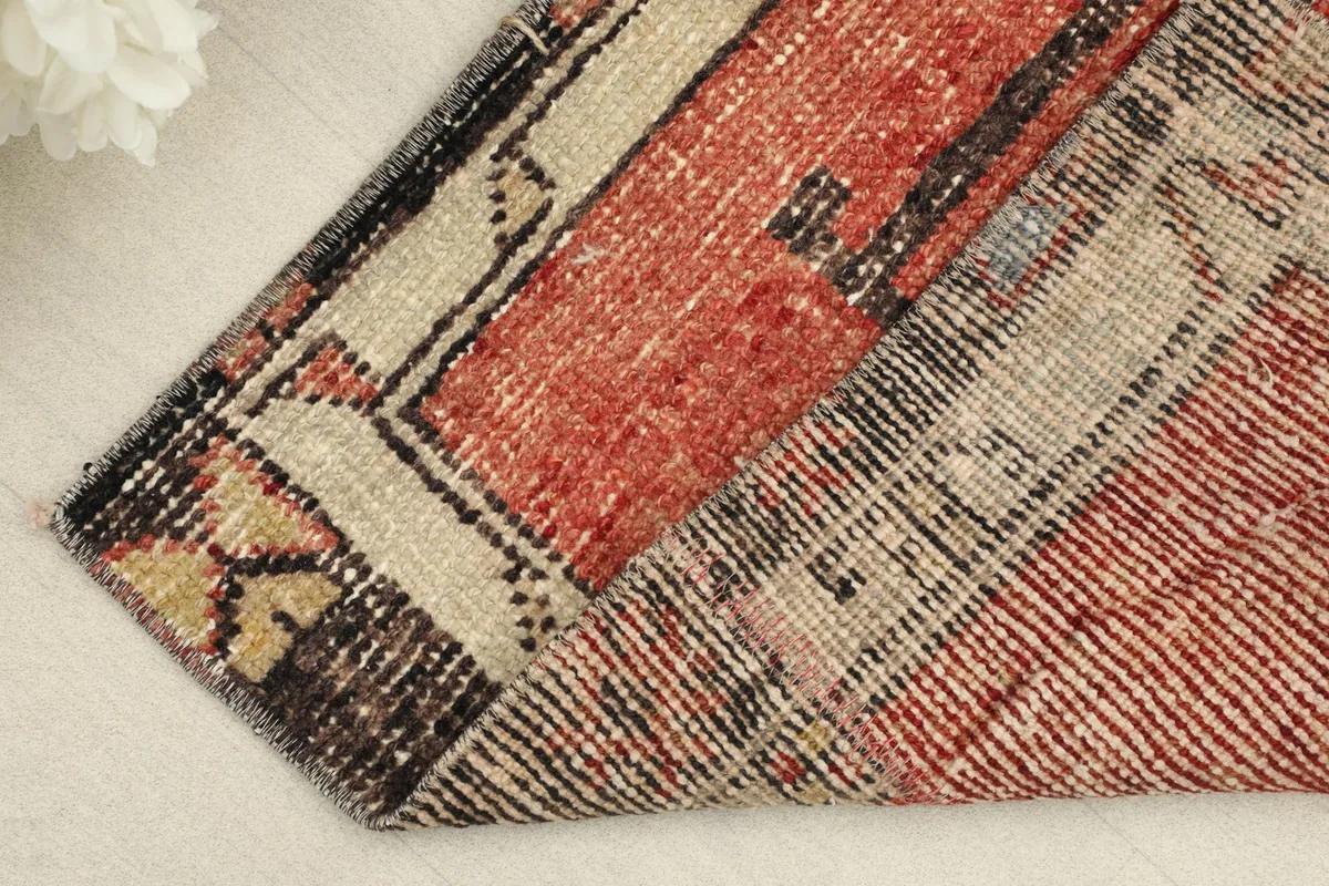 Rug folded to show the wool pile texture and cotton foundation on the underside.
