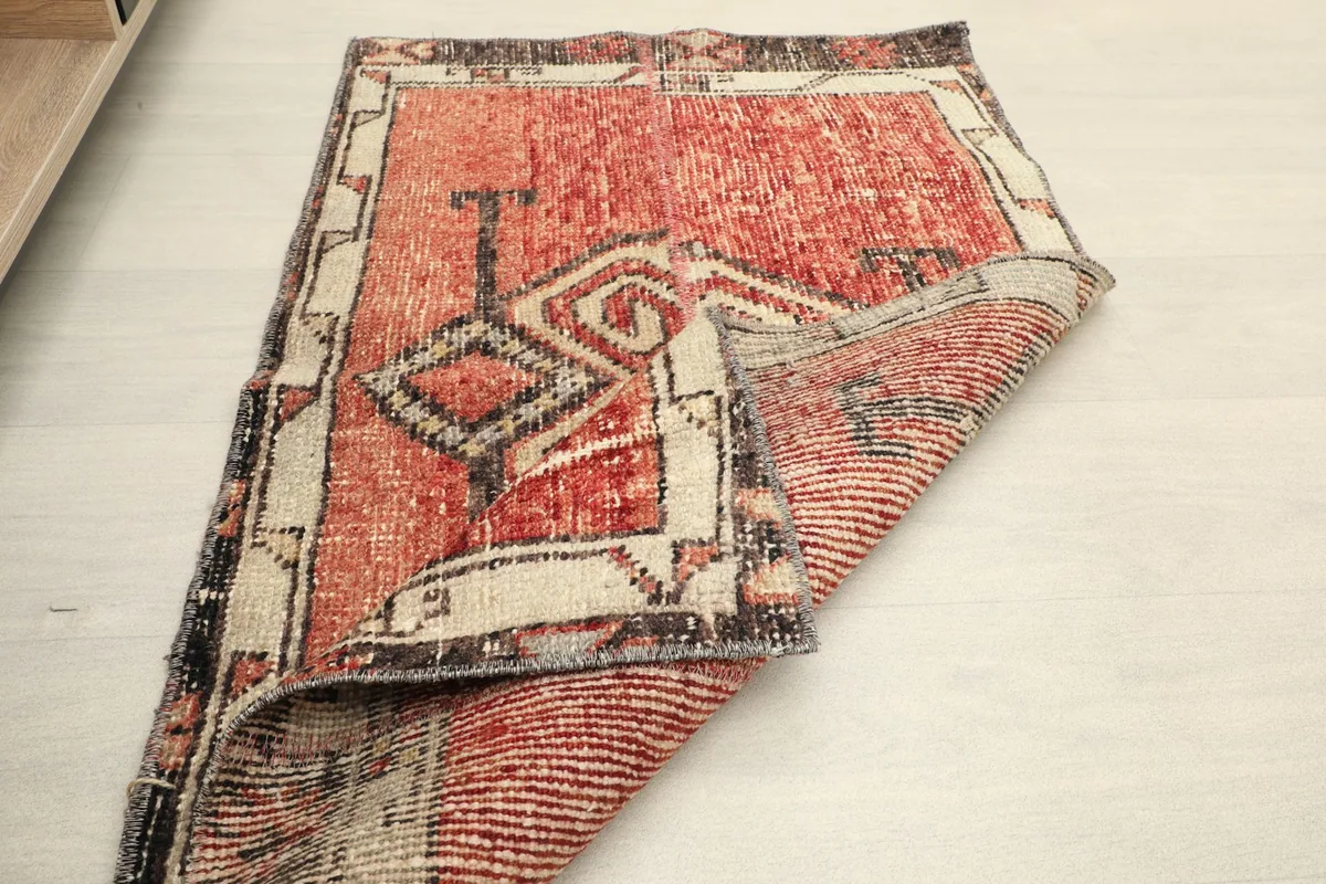 Another view of the rug partially folded, revealing the back of the hand-knotted construction.