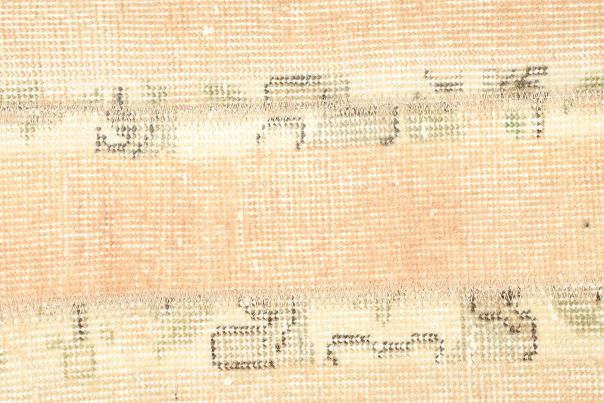 Detailed view of the hand-knotted wool pile and the intricate geometric motifs