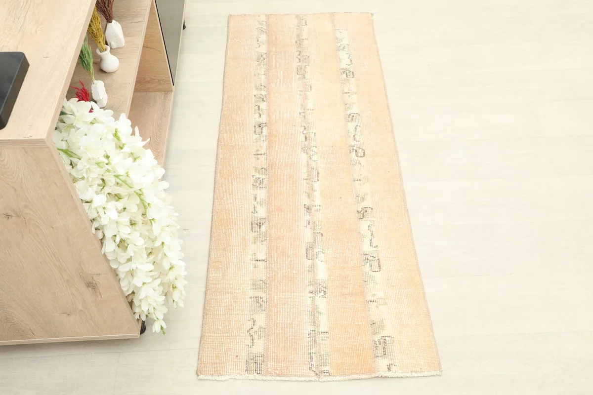 Overhead view of the beige and rust runner rug, showing its full length and pattern