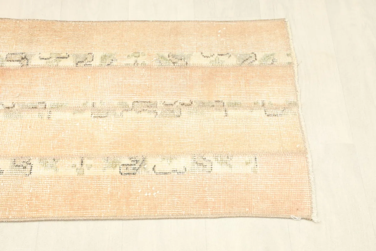Overhead view of the opposite end of the rug, showing slight variations in color and wear