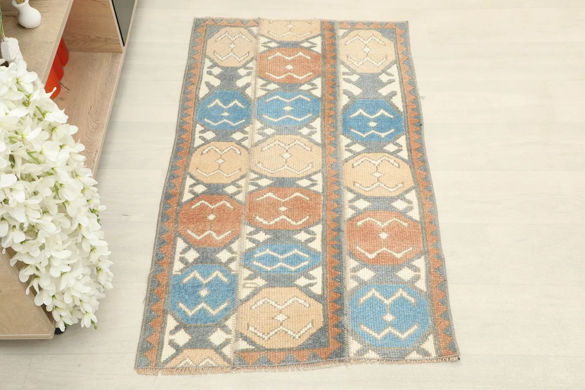 Overhead view of the hand-knotted wool rug, showing its full geometric pattern and colors