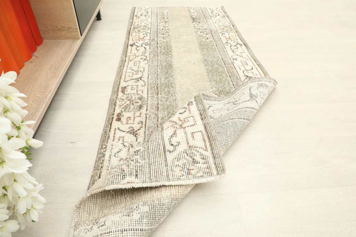 The runner rug folded to show its flexibility and the texture of the wool pile.