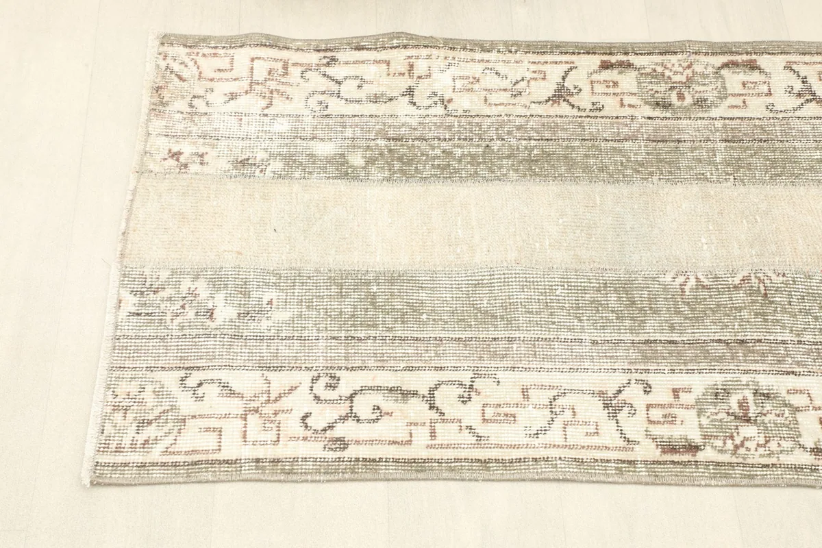 Overhead view showing a section of the runner, emphasizing the alternating beige and gray stripes with patterns.