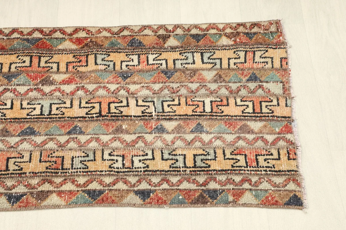 Angled view of the other end, showing the continuation of the geometric design and color variation.