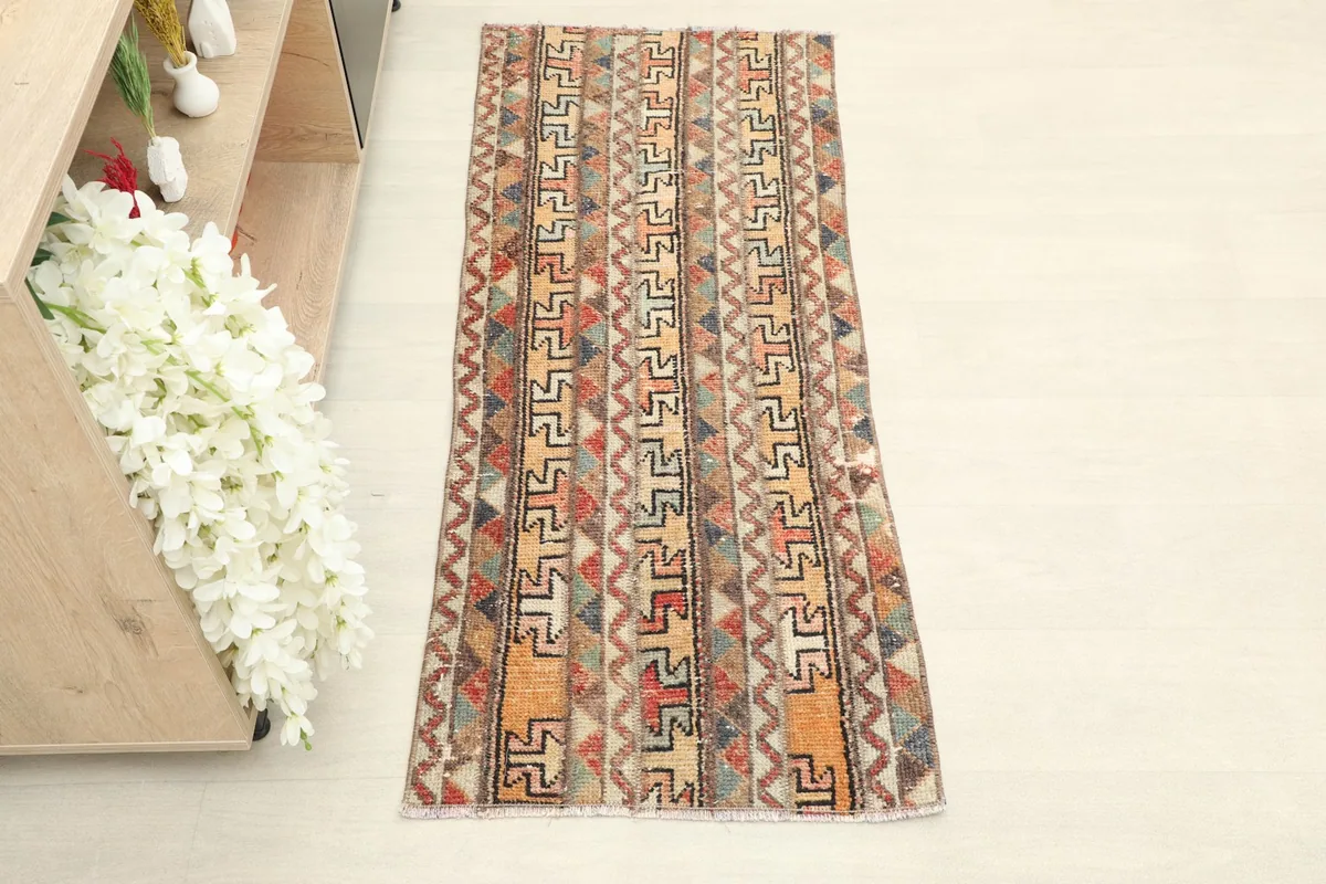 Overhead view of the vintage Anatolian runner, showcasing its full length and striped geometric design.