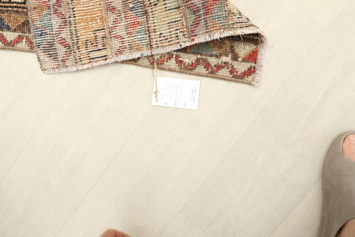 Top-down view of the runner with a size tag, providing scale reference for the 1'8" x 4'4" rug.