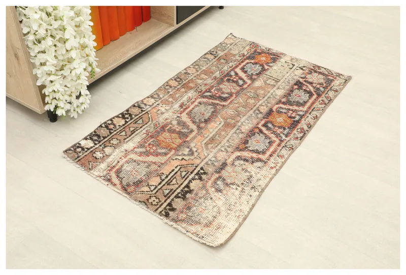 Full top view of the 2x4 vintage Anatolian rug with brown, beige, and orange geometric patterns