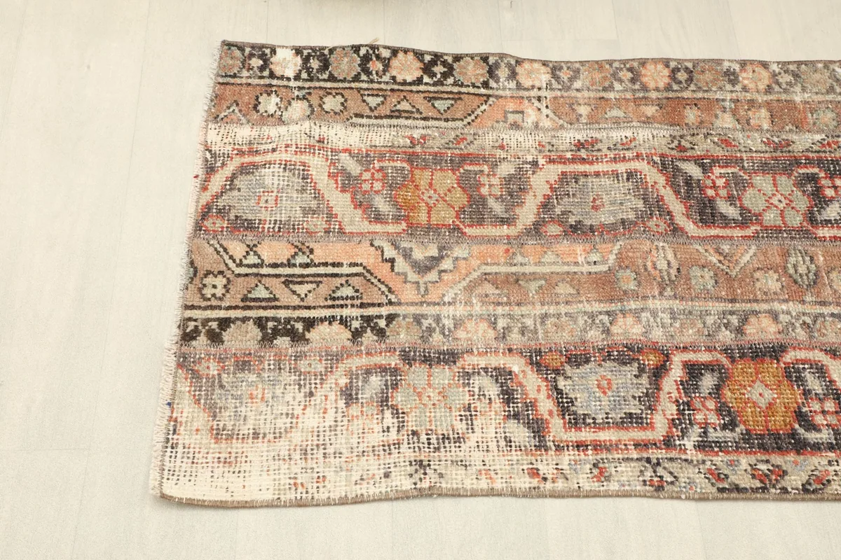Angled view of the rug's left side, showcasing the banded design and color variations