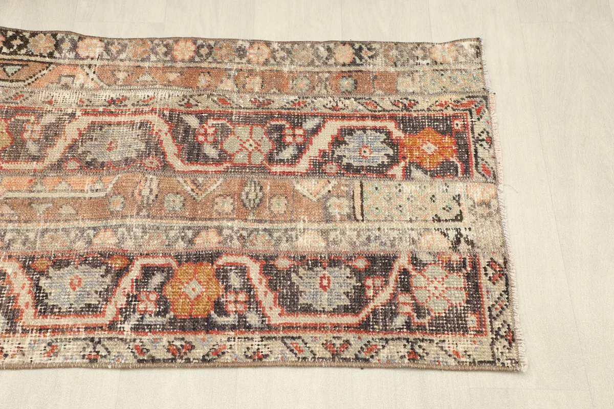 Angled view of the rug's right side, emphasizing the distressed character and patterns