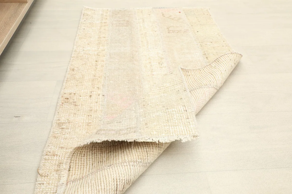 The rug partially folded, displaying its flexibility and the reverse side