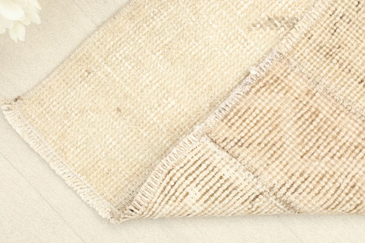 View of the back of the rug, revealing the cotton foundation and hand-knotting.