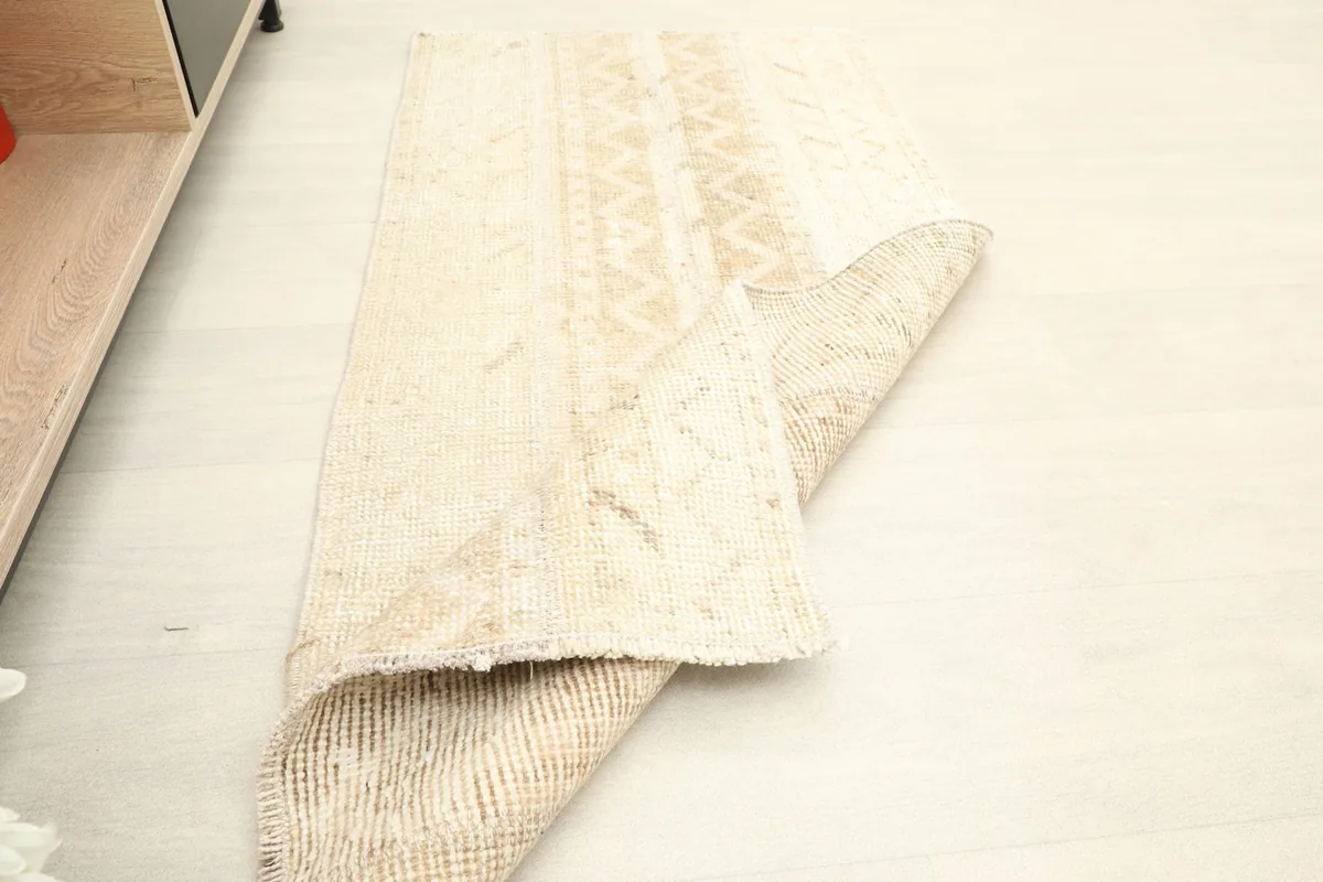 The rug folded to show its flexibility and the texture of the reverse side.