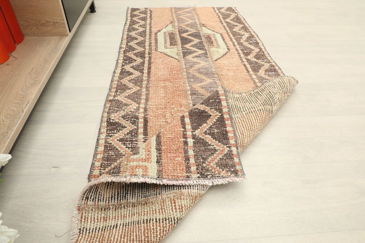 Angled view of the runner with a corner folded over, showing the texture and construction.