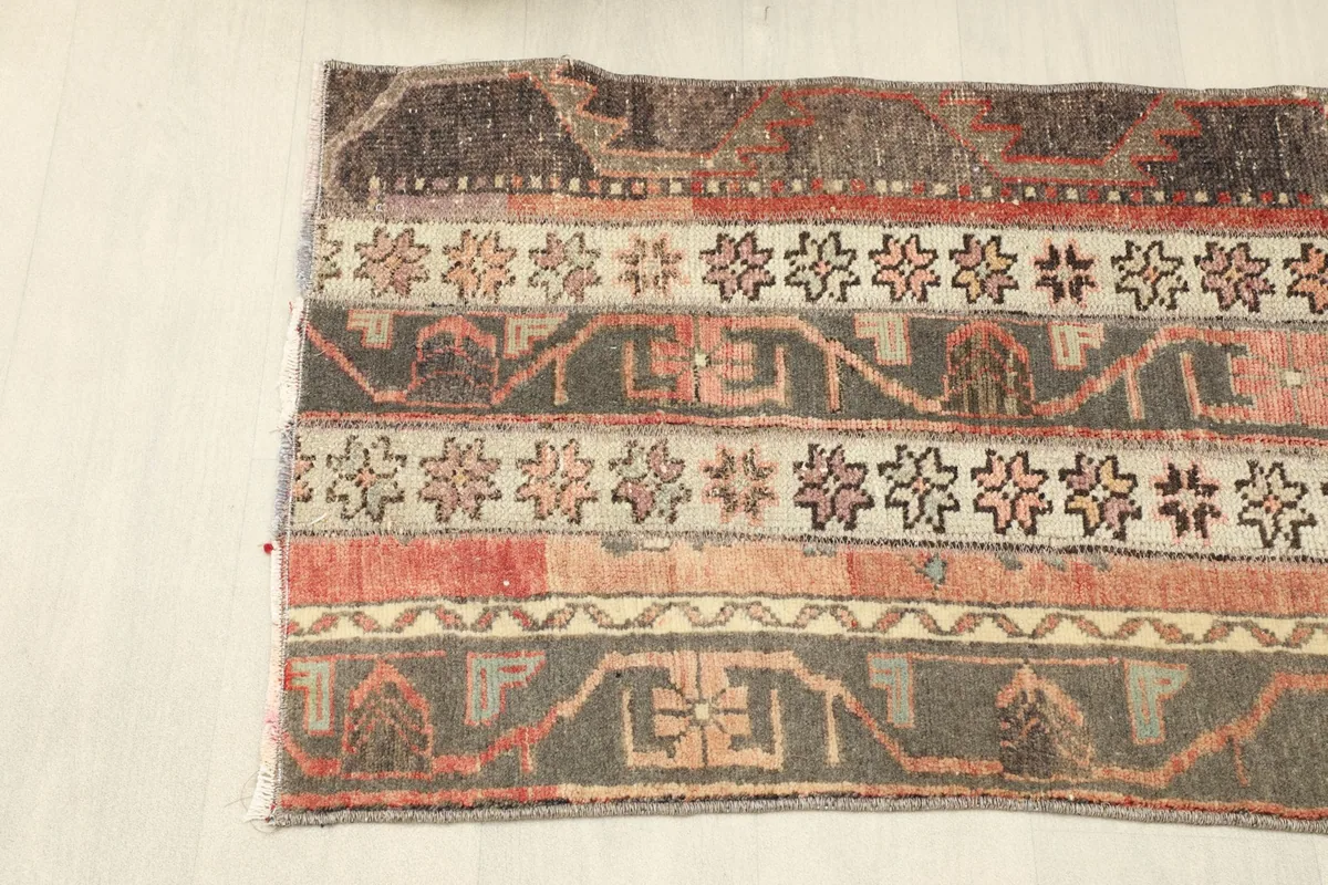 Angled view of one end of the rug, showing the consistent striped design and color palette.