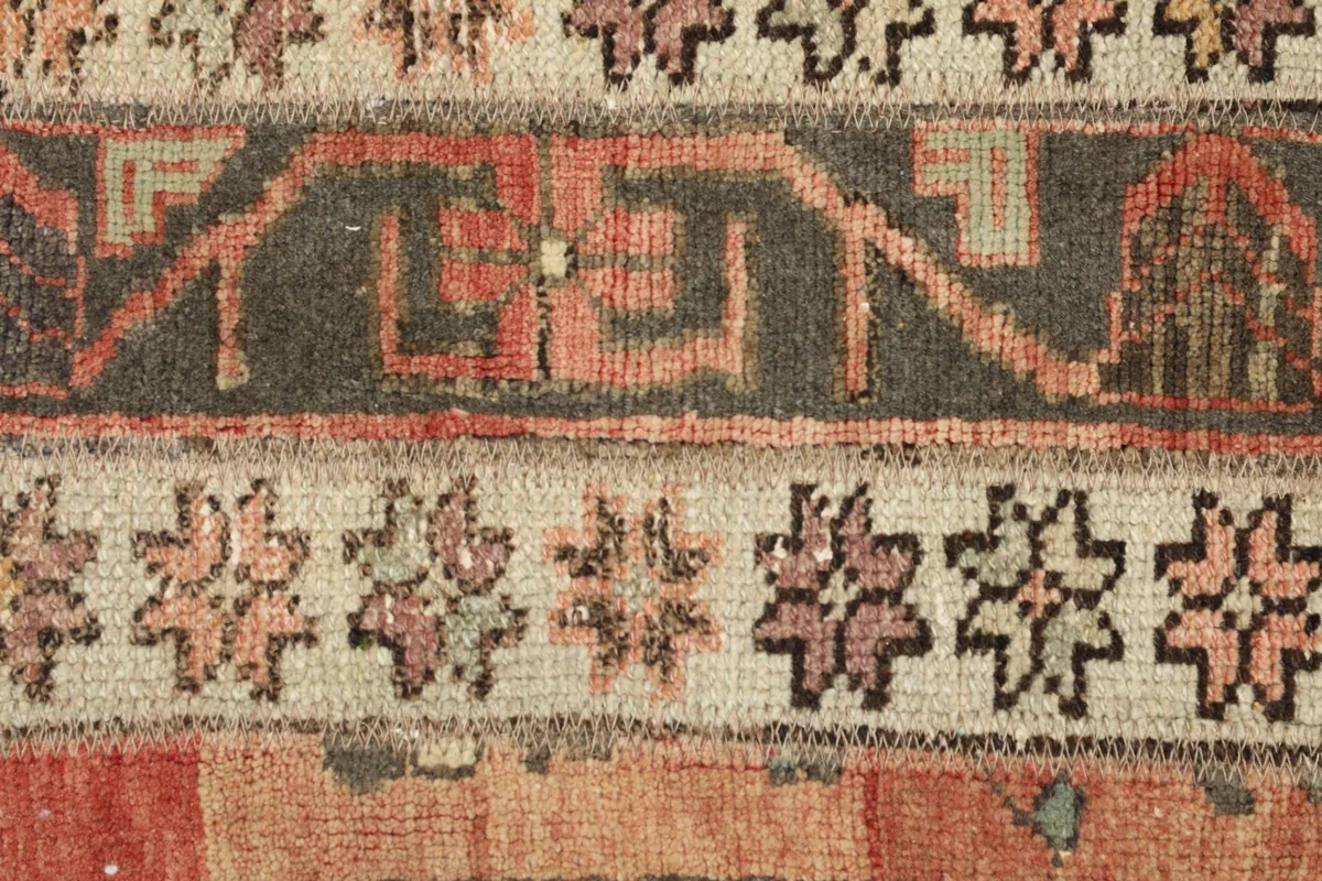 Detailed view of specific tribal geometric patterns and color variations in the rug's pile.