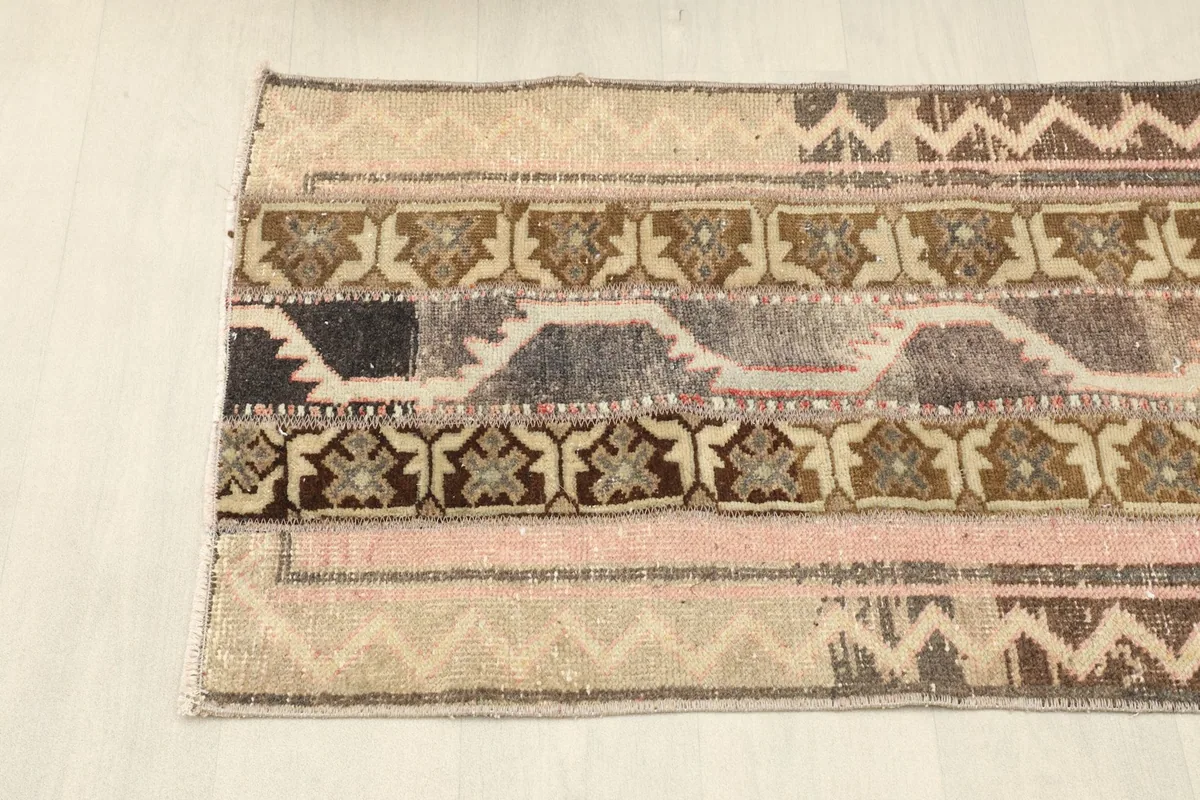 Overhead view of one end of the rug, displaying the diverse patched sections