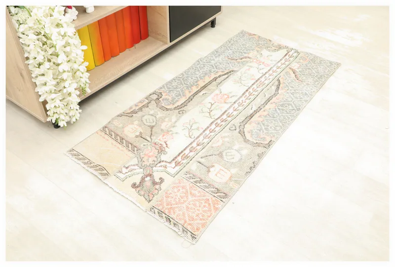 Full top view of the 2'4" x 3'9" rose beige patchwork vintage rug on a white background.