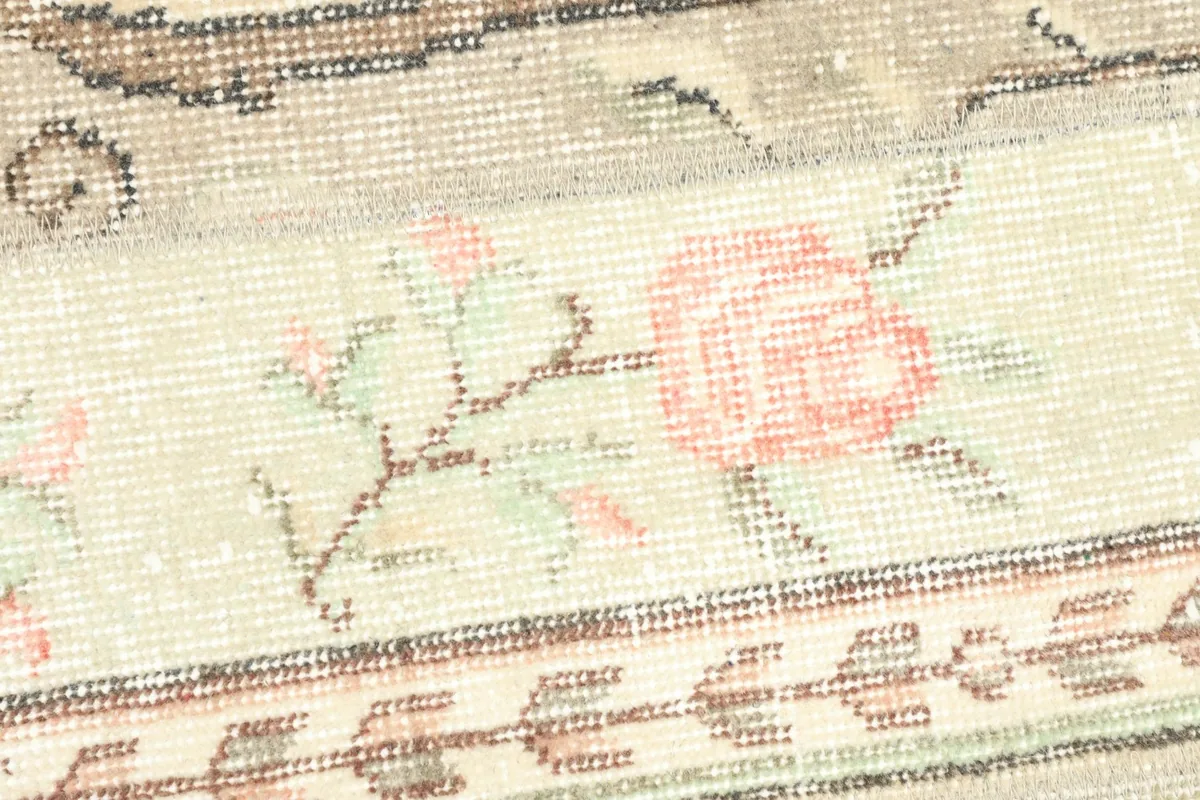 Detailed view of the central panel's rose floral design and low wool pile texture.