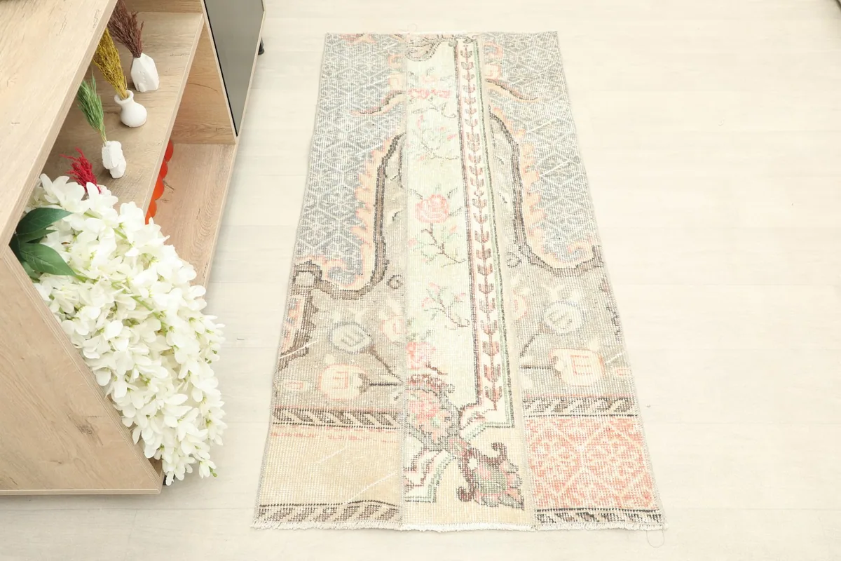 Overhead view of the vintage Anatolian rug, showcasing its full length and patchwork design.