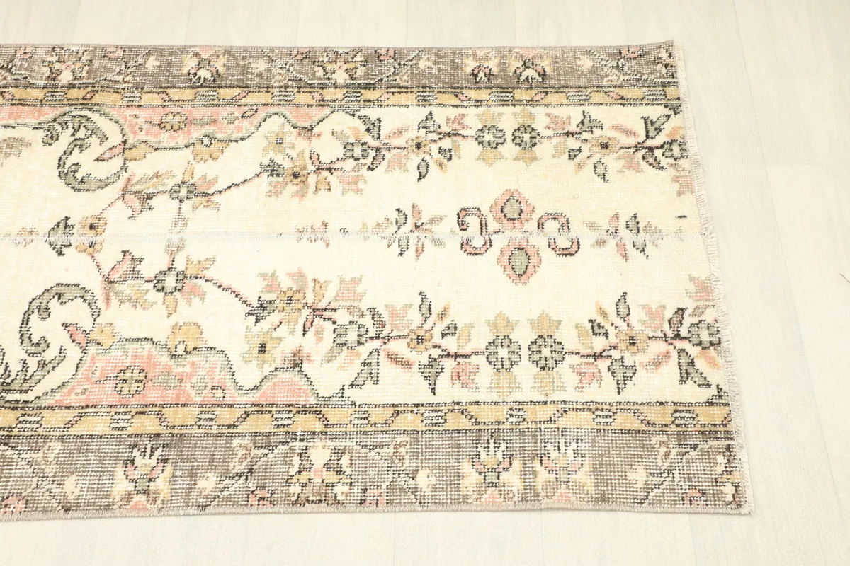 Close-up of the rug's central floral motifs and the contrasting geometric elements in the border.
