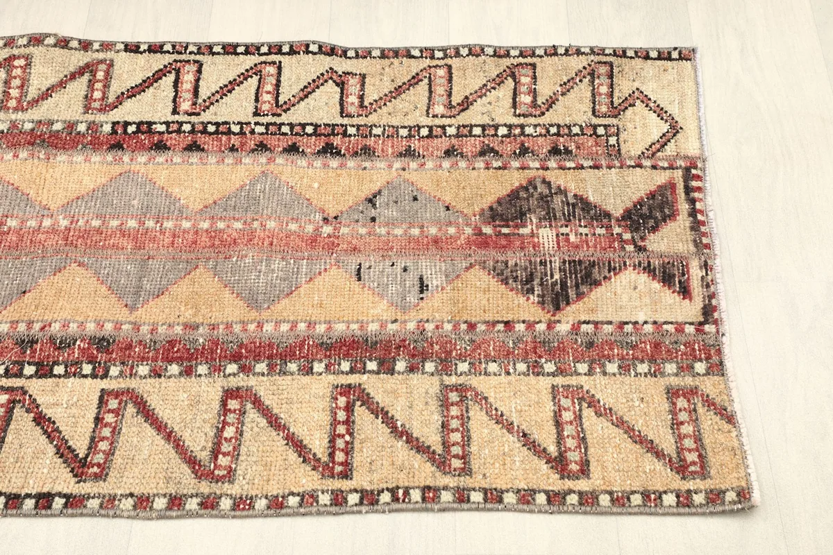 Another detail shot of the rug's patterns, highlighting the varied texture and color transitions.