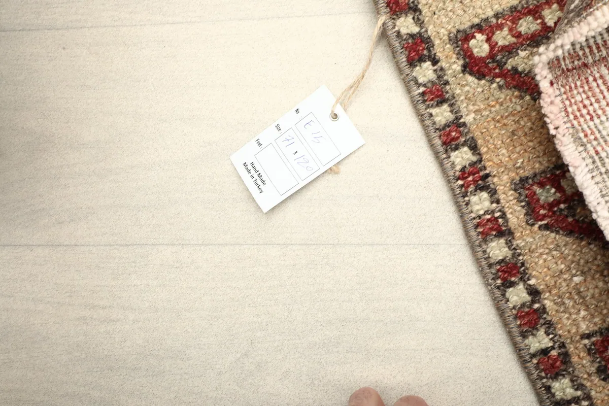 Overhead view of the rug with a product tag, showing its size and origin details.