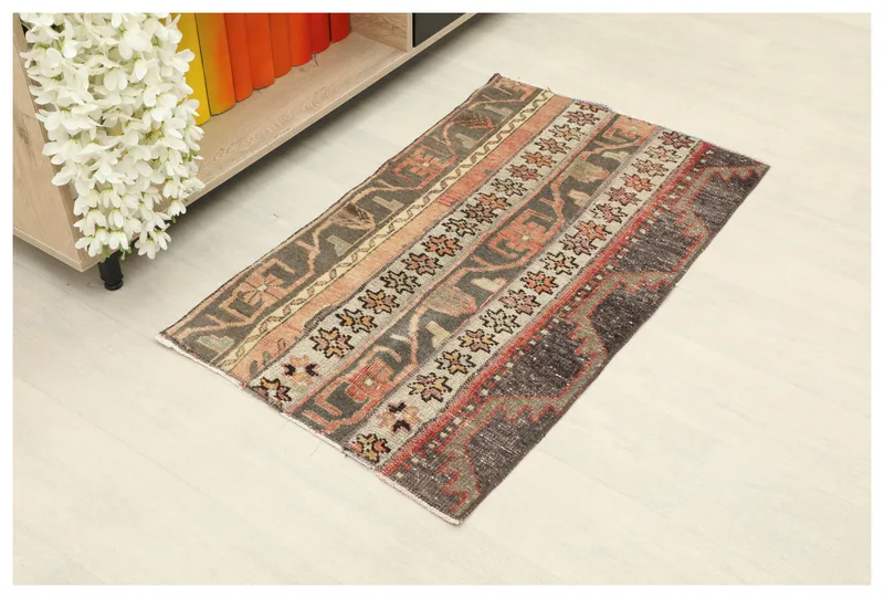 Full top view of the charcoal and rust striped vintage Anatolian wool rug on a white background.