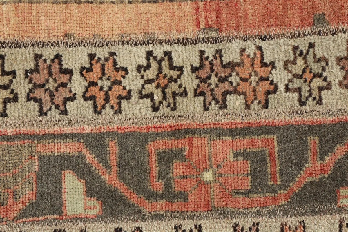 Detailed view of the intricate geometric motifs and color blending in the rust and beige stripes.