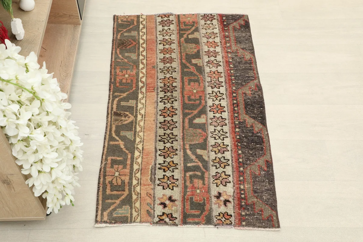 Overhead view of the hand-knotted vintage rug, showing its full striped pattern and colors.