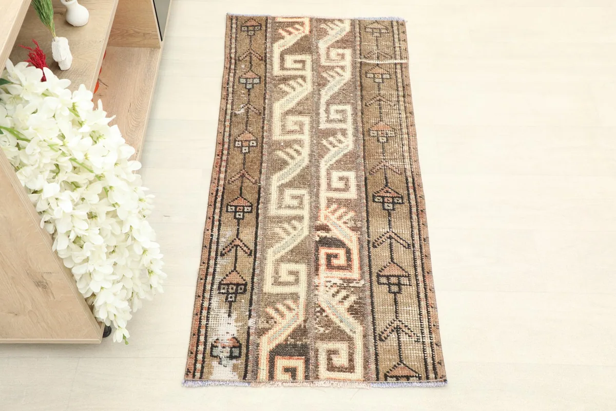 Overhead view of the hand-knotted wool rug, showing its full length and tribal design