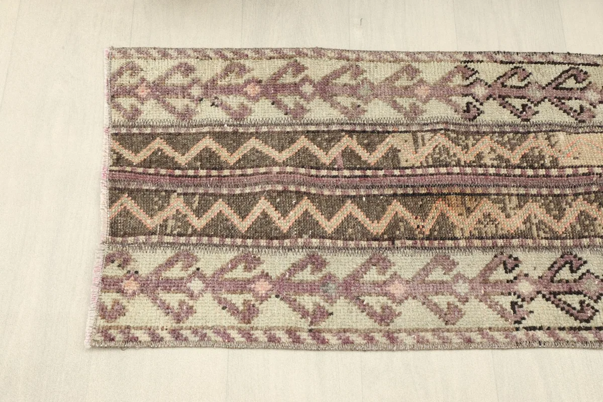 Overhead view focusing on the upper half of the rug, displaying its intricate tribal designs.