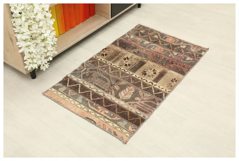 Full top view of the 2x4 vintage Anatolian patchwork rug with earth tones
