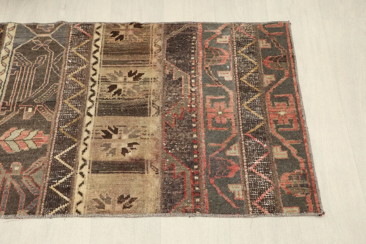 Side angle view of the rug showing its rectangular shape and various design blocks