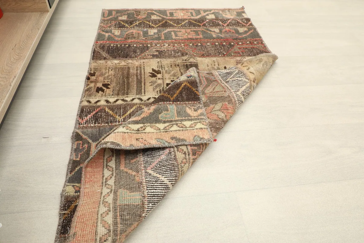 Rug partially folded, illustrating its flexibility and construction