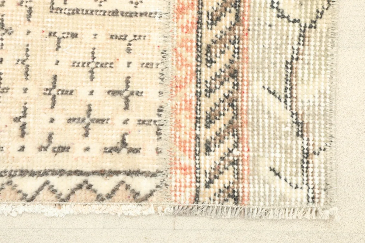 Close-up showing the varied patterns and textures where different sections of the rug meet.