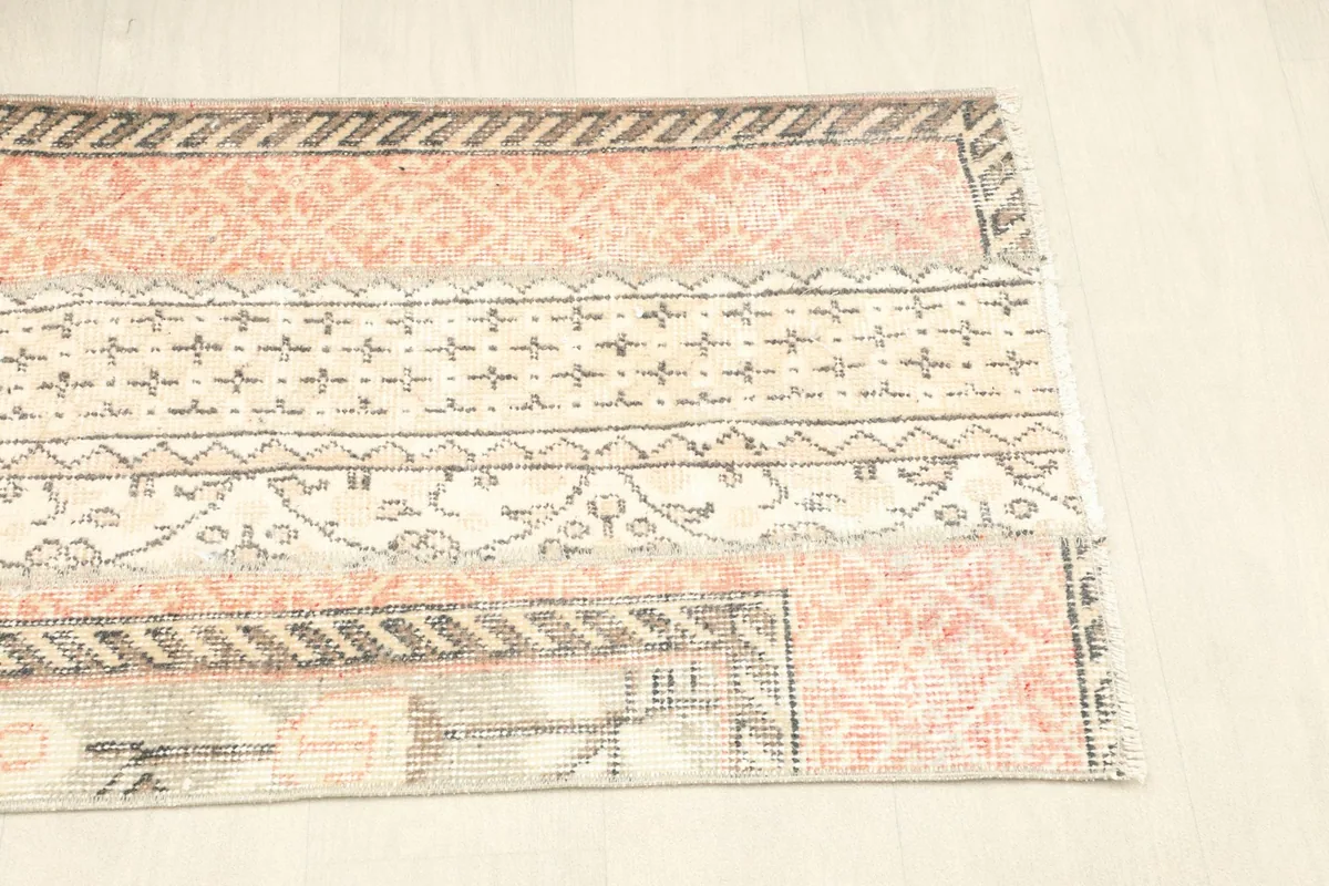 Overhead shot of the other end of the rug, displaying the full breadth of the patchwork design.