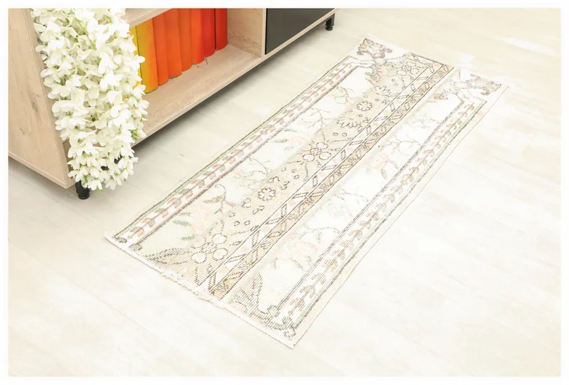 Full top view of the 1'10" x 4'6" ivory and rose vintage Anatolian runner rug on a white background.