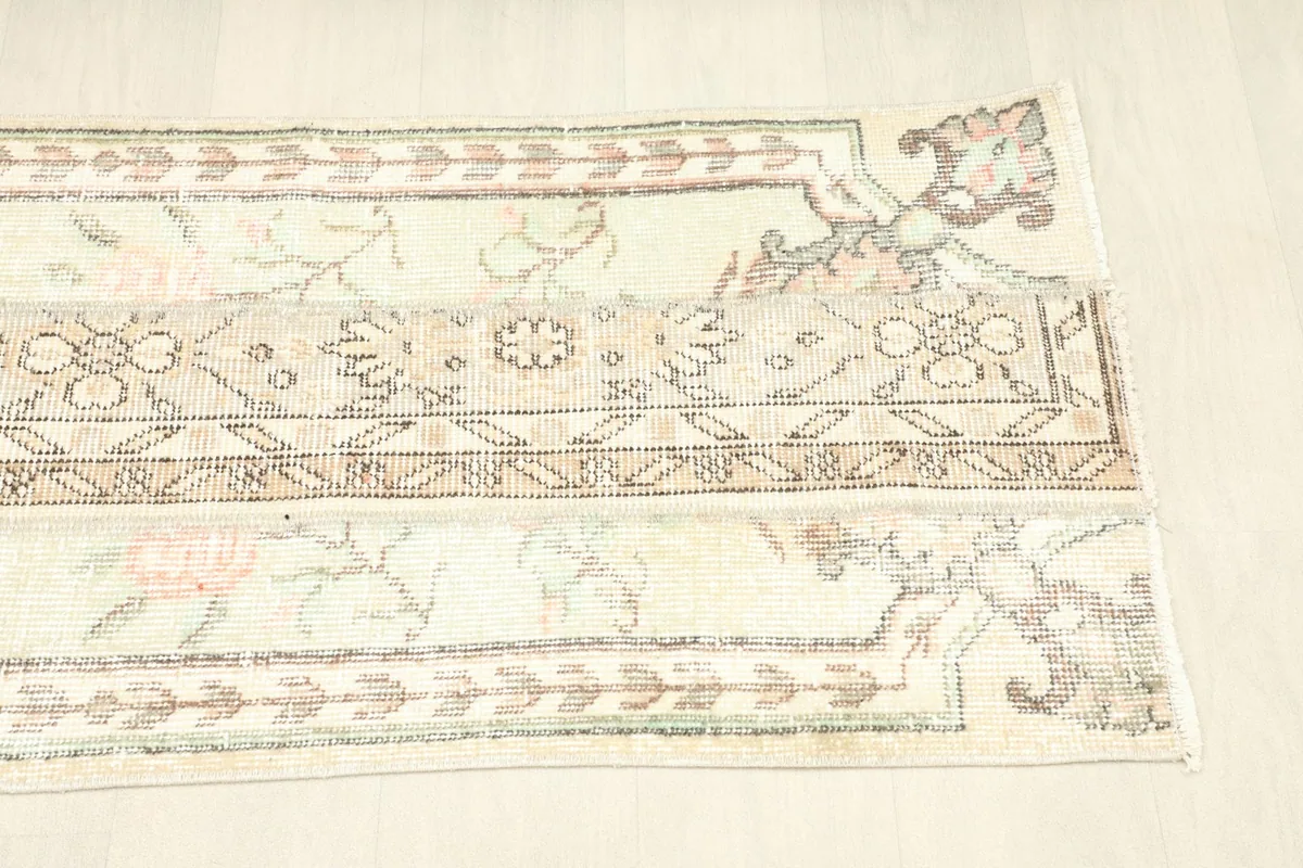 View of the rug folded to show its flexibility and the subtle color variations across its surface.