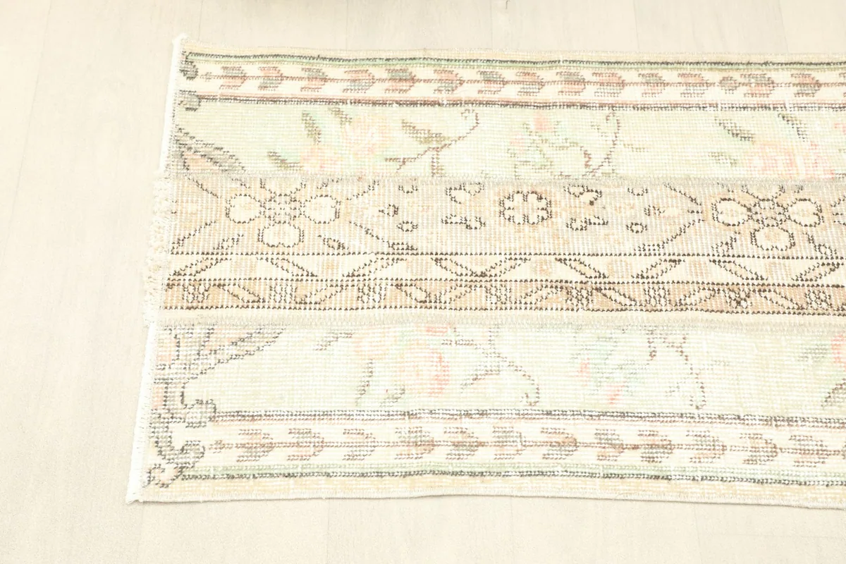 Overhead shot of a section of the runner, showcasing the patchwork-like design and muted color palette.