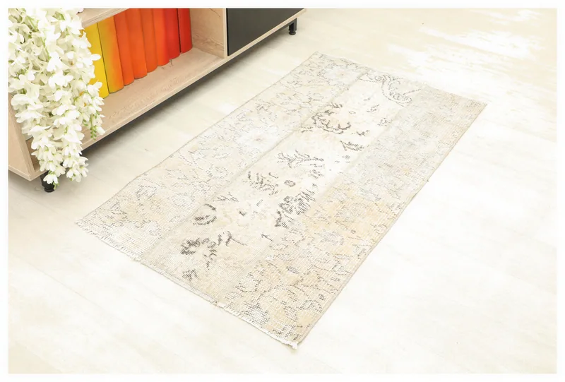 Full top view of the 2x4 beige and gray vintage Anatolian rug on a white background.