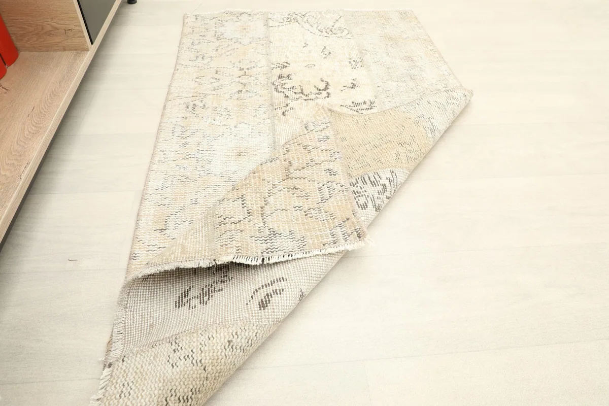 The rug folded to reveal its thickness and the texture of both the front and back.