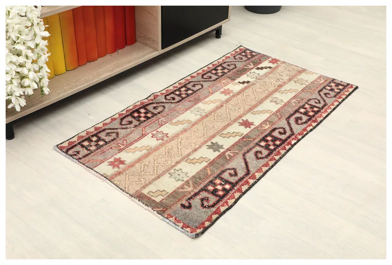 Full top view of the beige and cream striped vintage Anatolian rug with geometric patterns