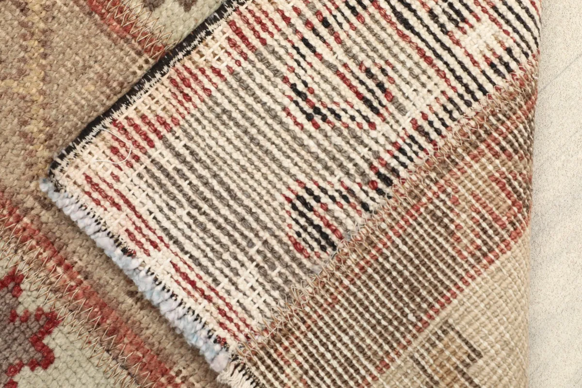 Close-up of the rug's back, revealing the hand-knotted wool pile on a cotton foundation
