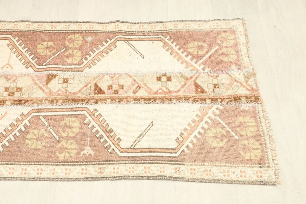Detail shot of the other end of the rug, highlighting the symmetrical tribal designs.