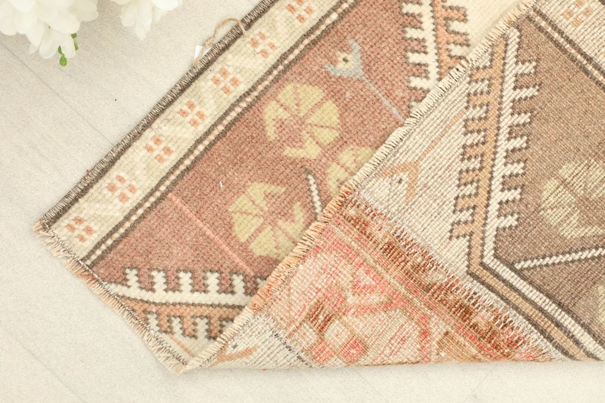 Folded corner of the rug, showing the reverse side and the construction of the hand-knotted wool.