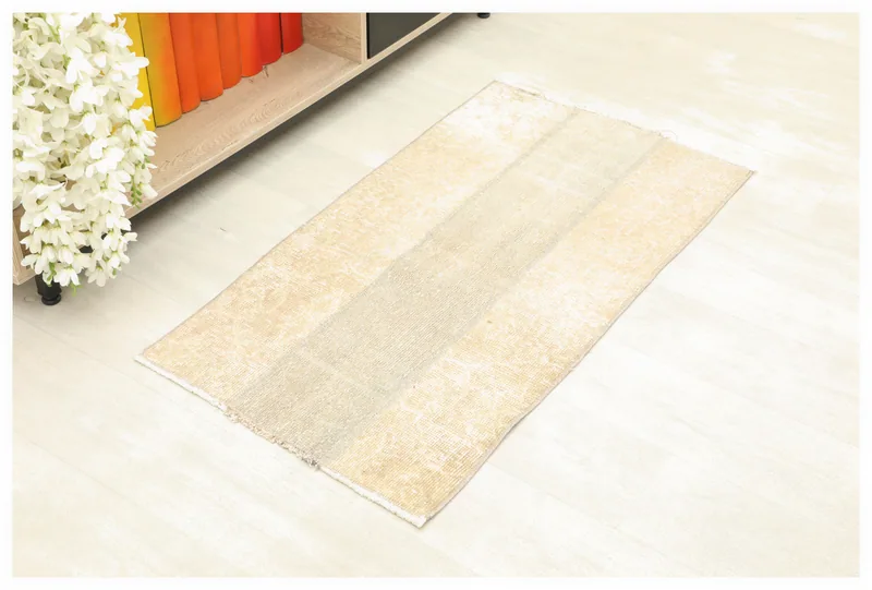 Full top view of the 1'10" x 3'5" beige panel vintage Anatolian rug on a white background.