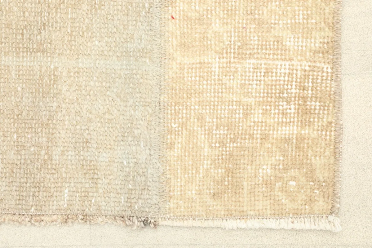 Close-up detail of the rug's surface, highlighting the texture and color variation between panels.